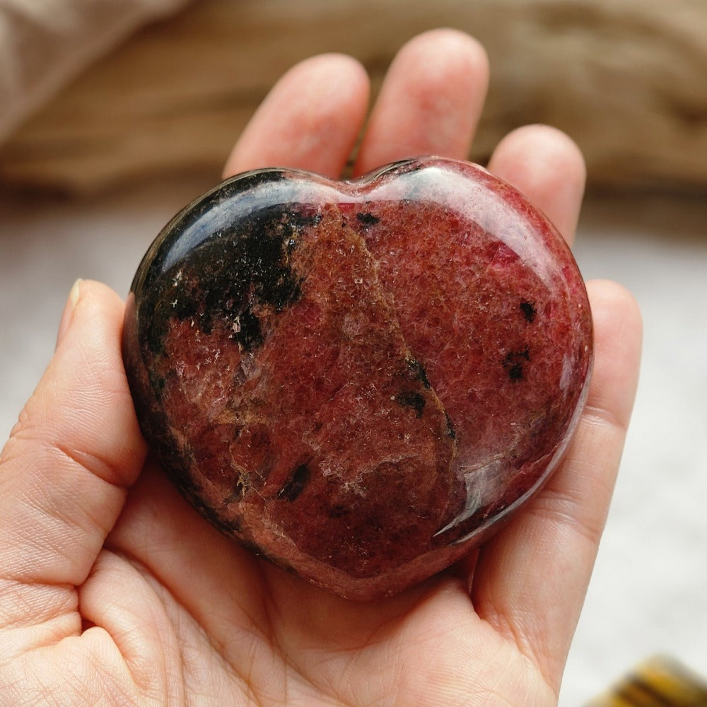 Rhodonite Crystal Heart in hand